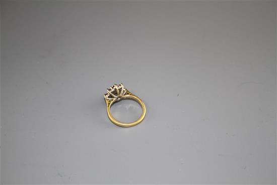 A modern 18ct gold, ruby and diamond set flower head cluster ring, size I, gross weight 3.7 grams.